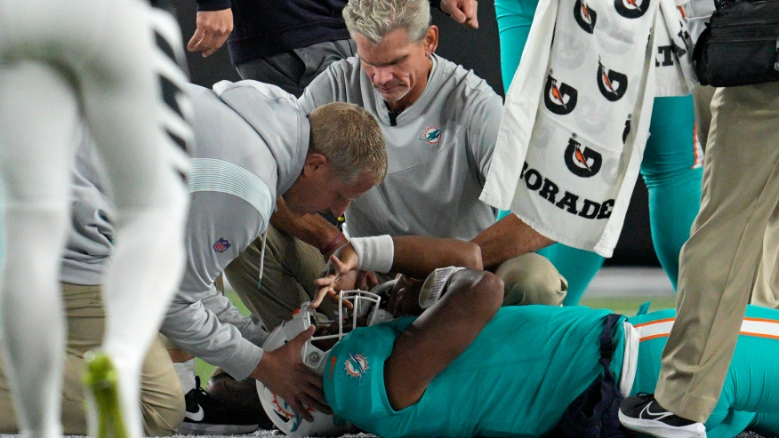 Miami Dolphins quarterback Tua Tagovailoa being examined after an injury. Image credit to Jeff Dean.