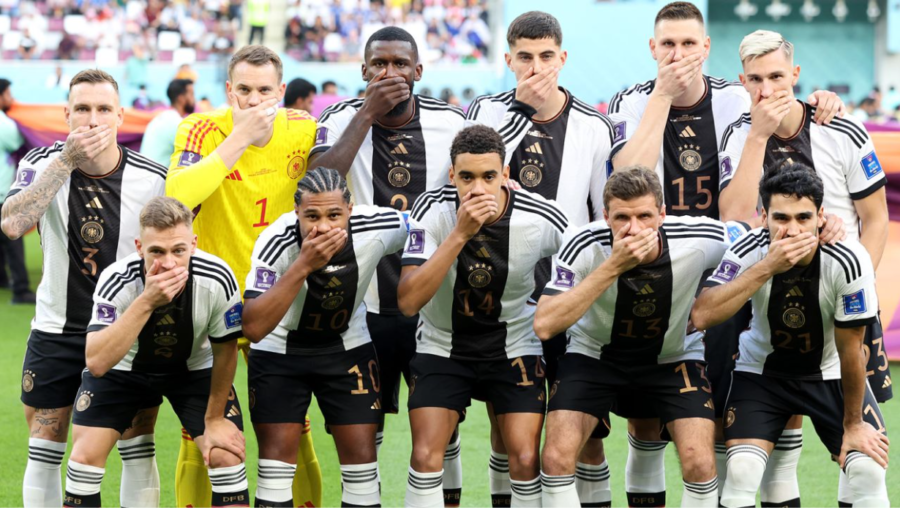 The German National Team covered their mouths in protest as they lined up for their pre-game photo ahead of their opening match against Japan. Photo credit to Alexander Hassenstein