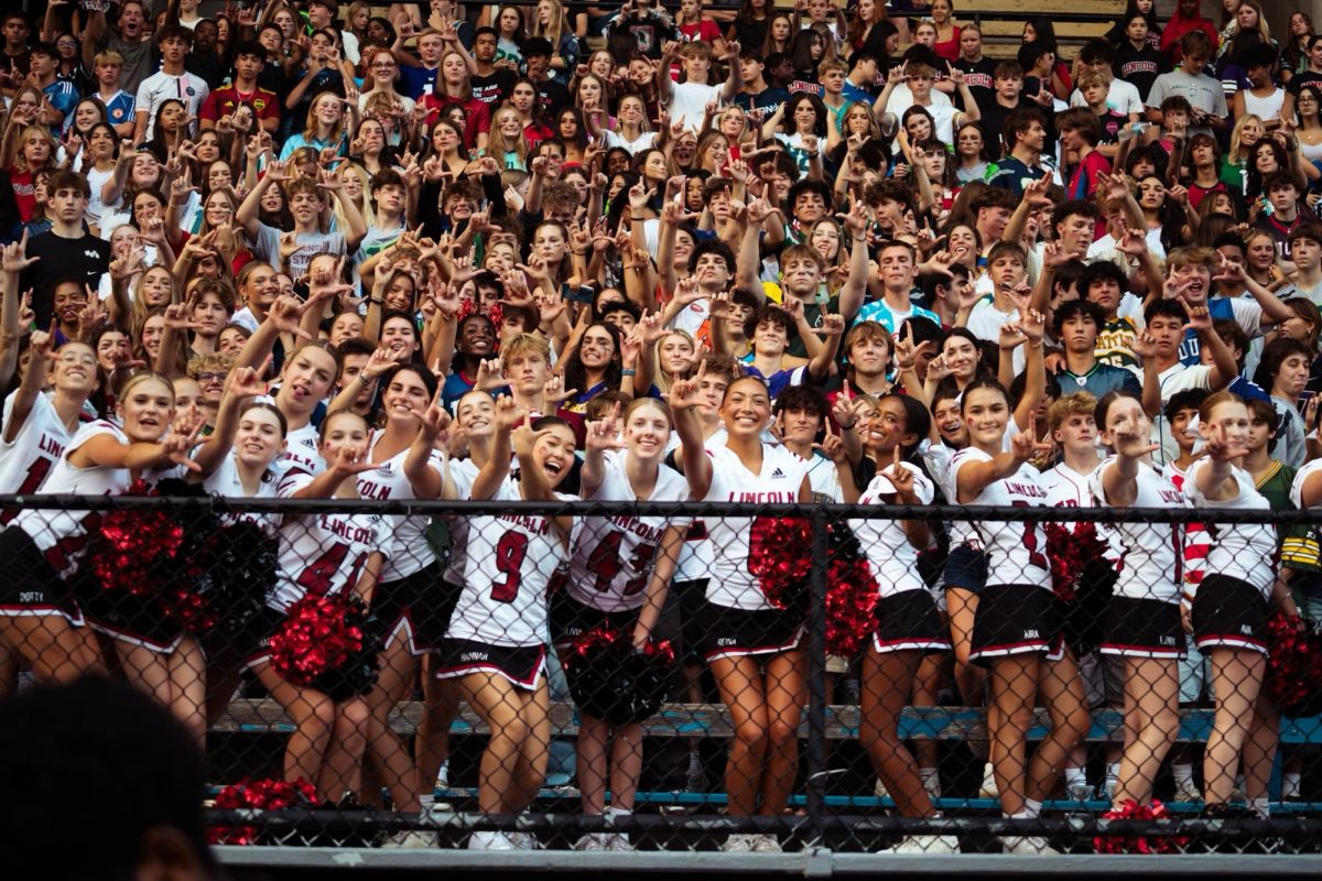 The LHS cheer team leading the Lincoln student section at a football game. Photo credit to Wyatt Kaufman.