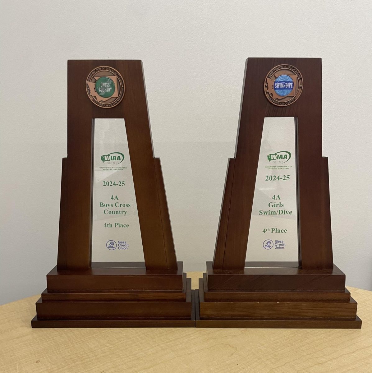 Boys Cross Country and Girls Swim/Dive trophies. Photo credit to Levi Hanscom.